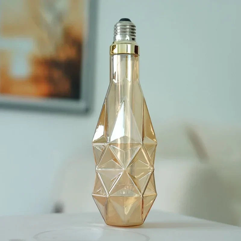 D78-Edison-bulb-with-diamond-cut-amber-glass-glowing-warmly
